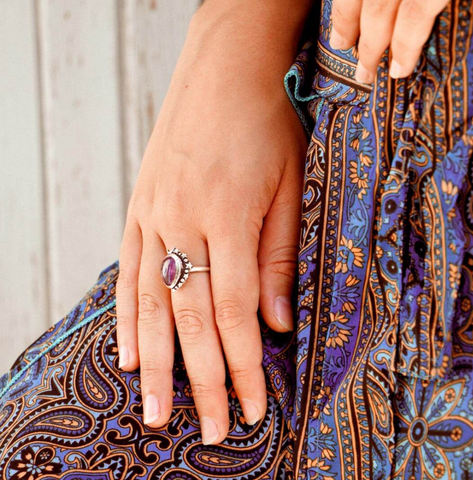celestial purple amethyst ring with a crescent moon on a boho girl wearing a purple dress
